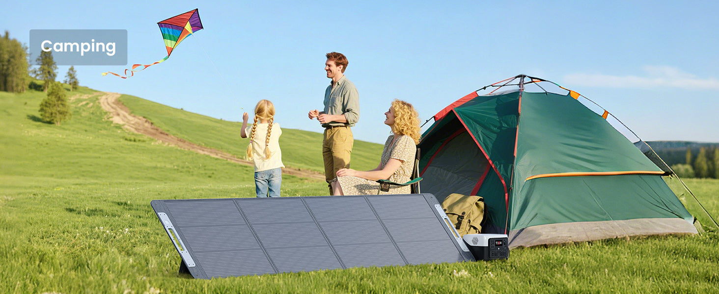 Callsun 220W portable solar panel set up at a sunny hillside campsite with a green tent, power station, and a family flying a kite.