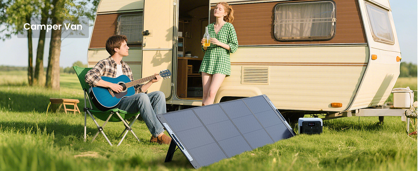 Callsun 220W portable solar panel deployed in front of a camper van at a campsite while a man plays guitar and a woman relaxes.