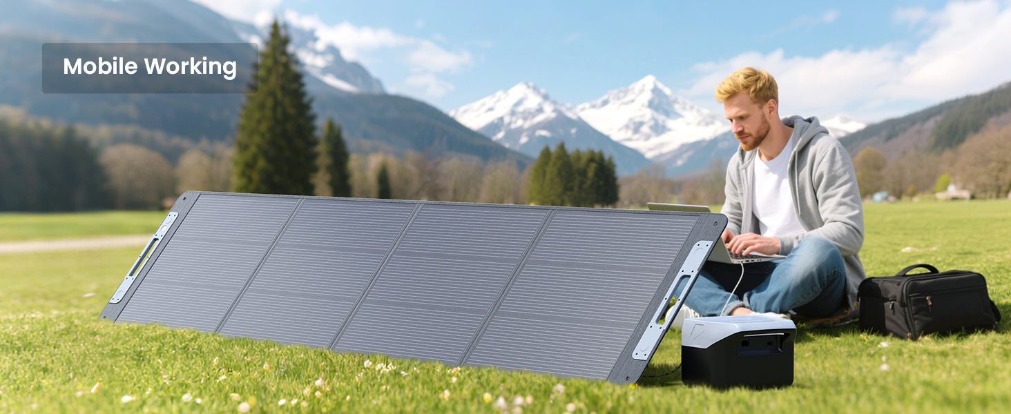 Callsun 220W N-Type portable solar panel powers a man working on a laptop with a power station in a mountain meadow.