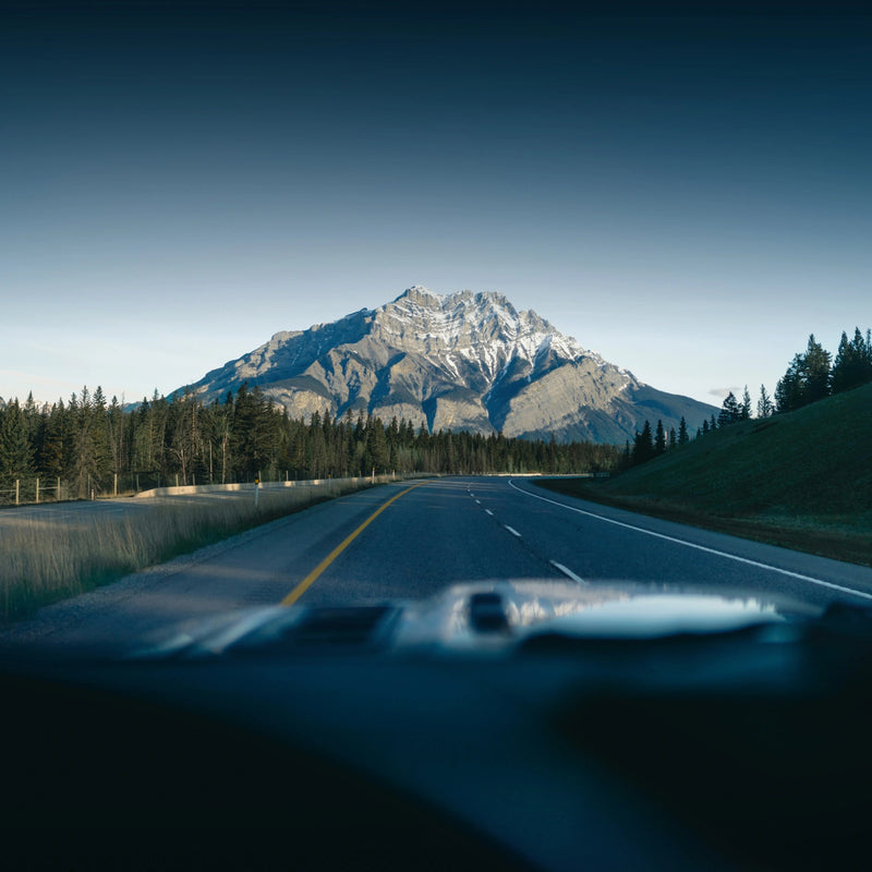 Scenic road trip toward mountains, representing the freedom and off-grid adventure spirit of Callsun solar power solutions.